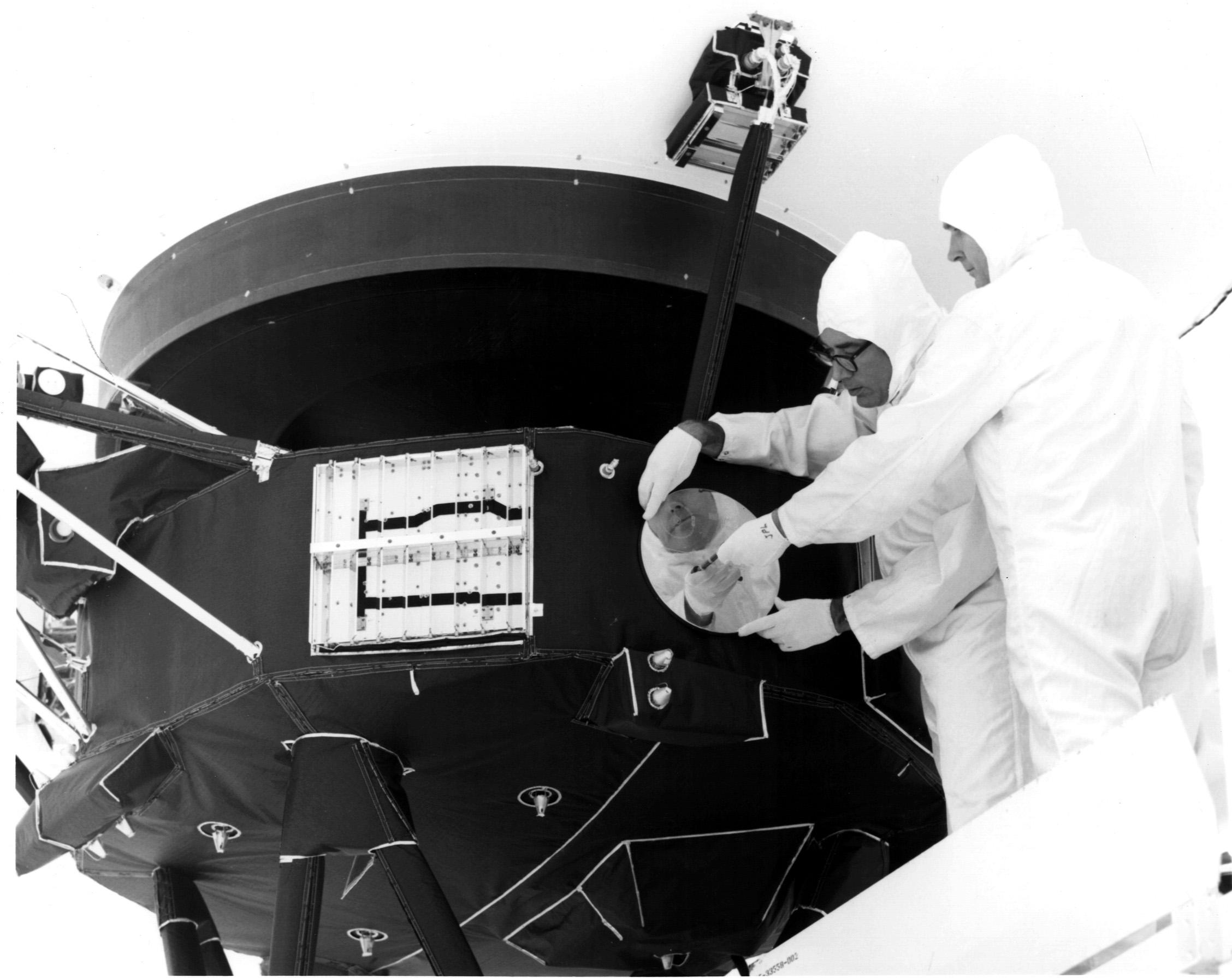 Engineers install the Golden Record cover on the side of Voyager 1